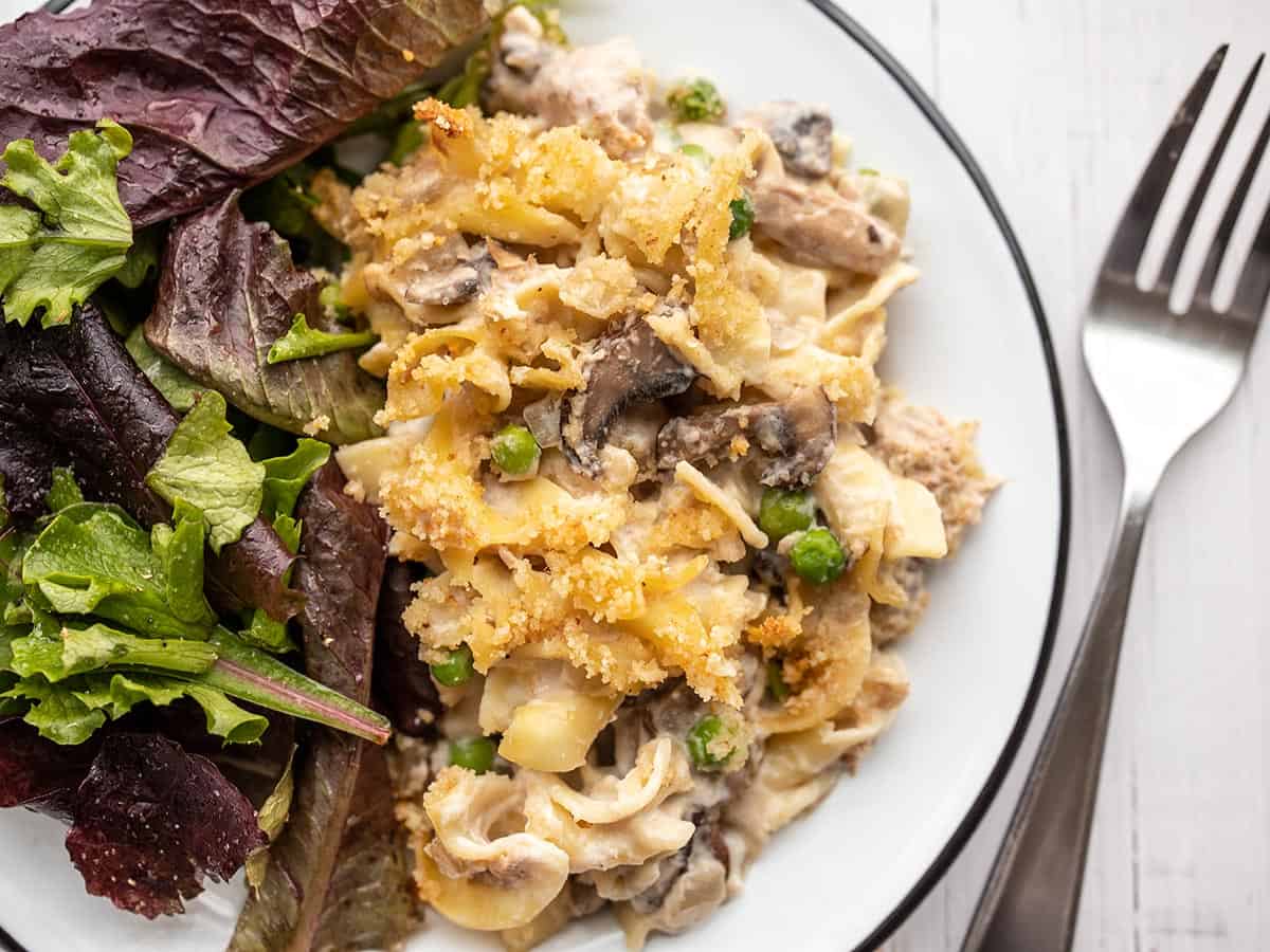 overhead view of tuna noodle casserole on a plate with salad