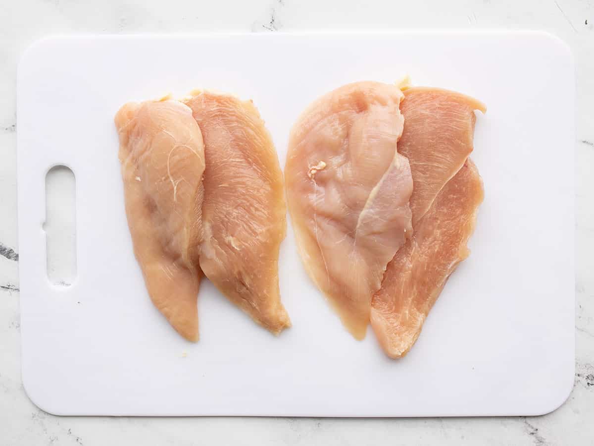 Filleted chicken breasts on a cutting board