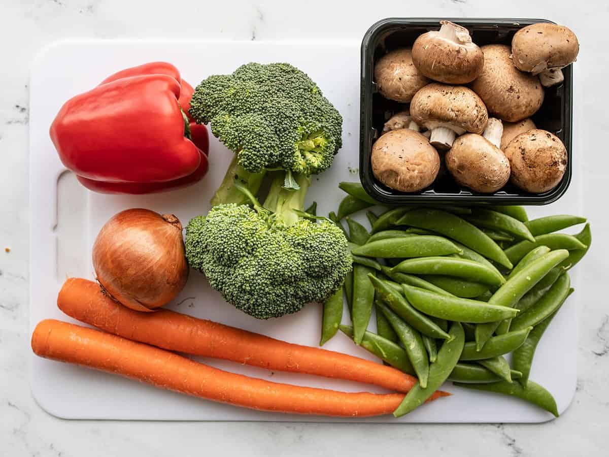 Whole vegetables on a cutting board.