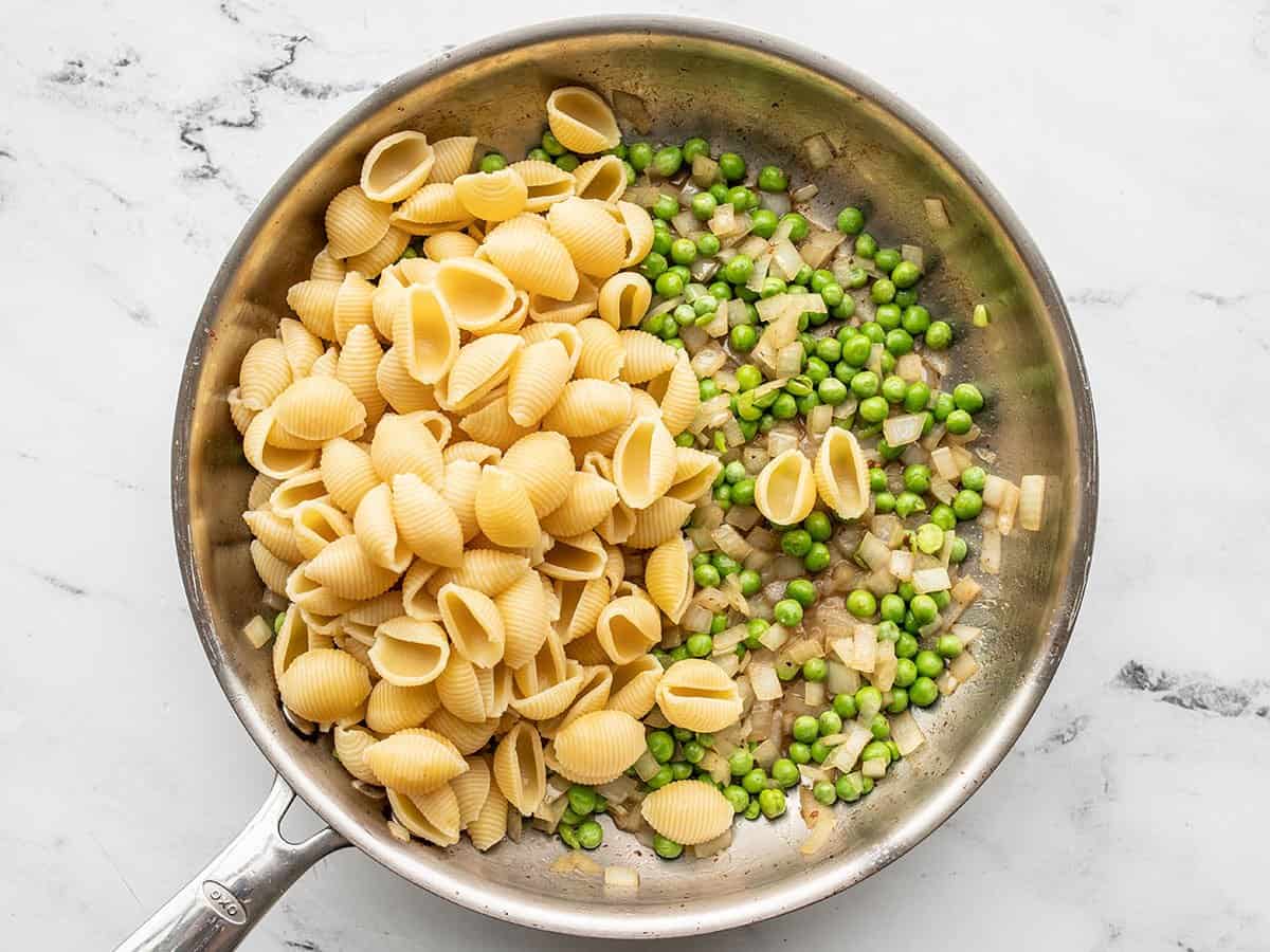 Drained pasta added back to the skillet.