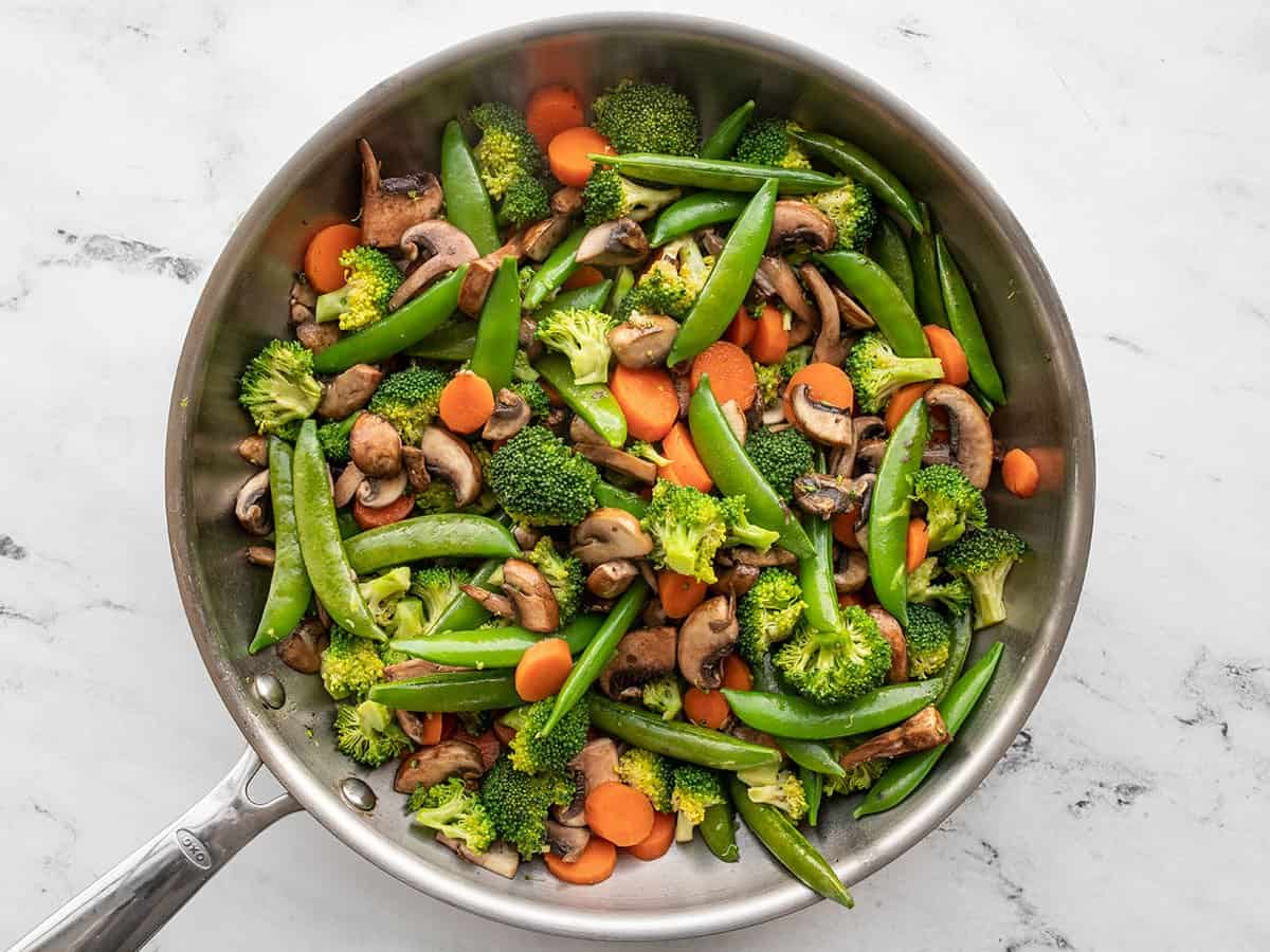 Mushrooms and peas added to the skillet.