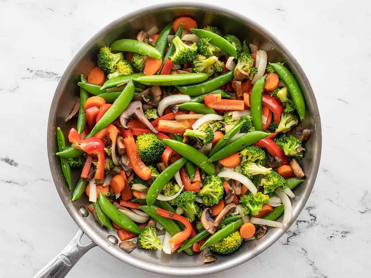 peppers and onions added to the skillet.