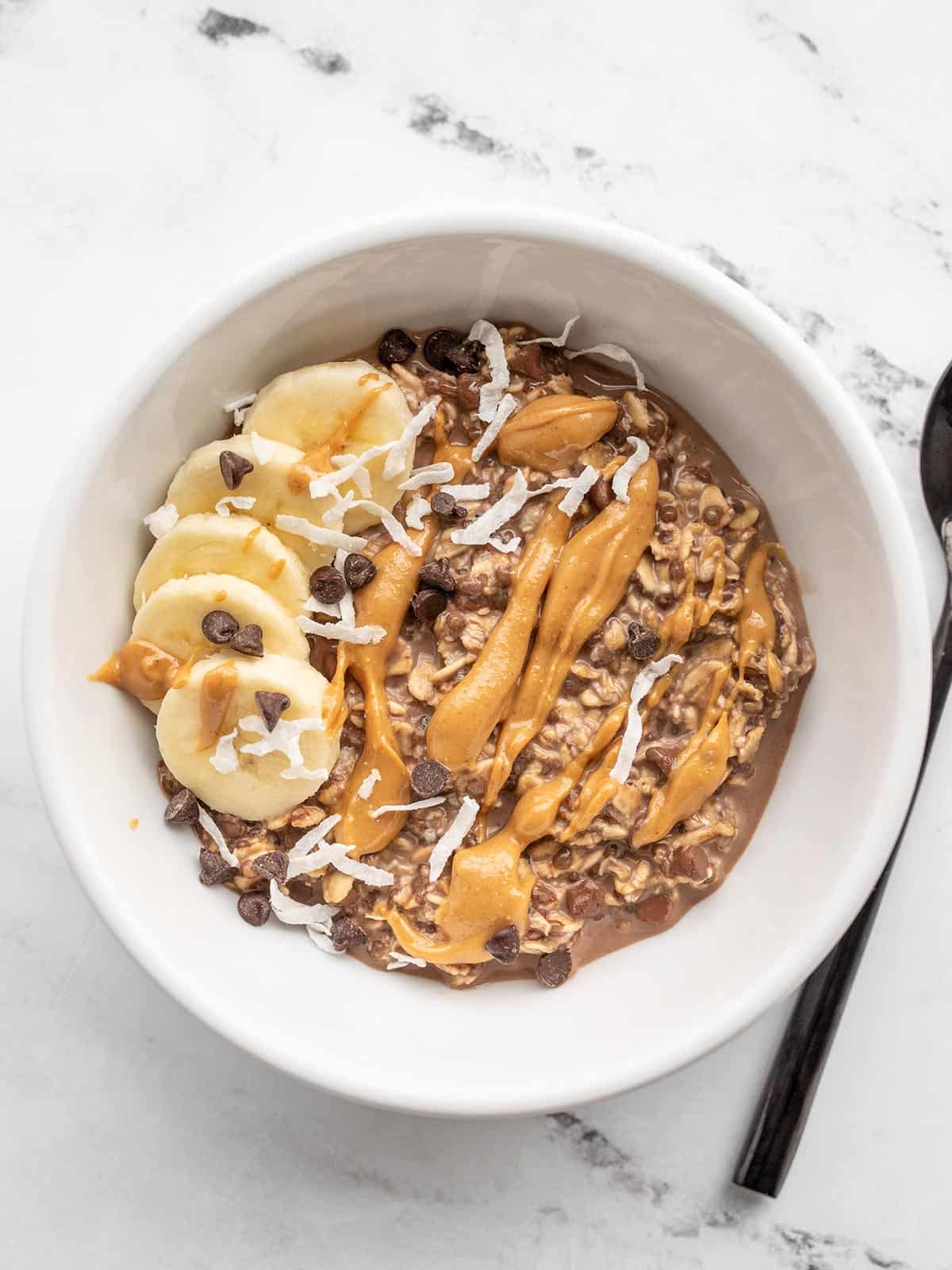 Overhead view of a bowl full of double chocolate overnight oats with toppings