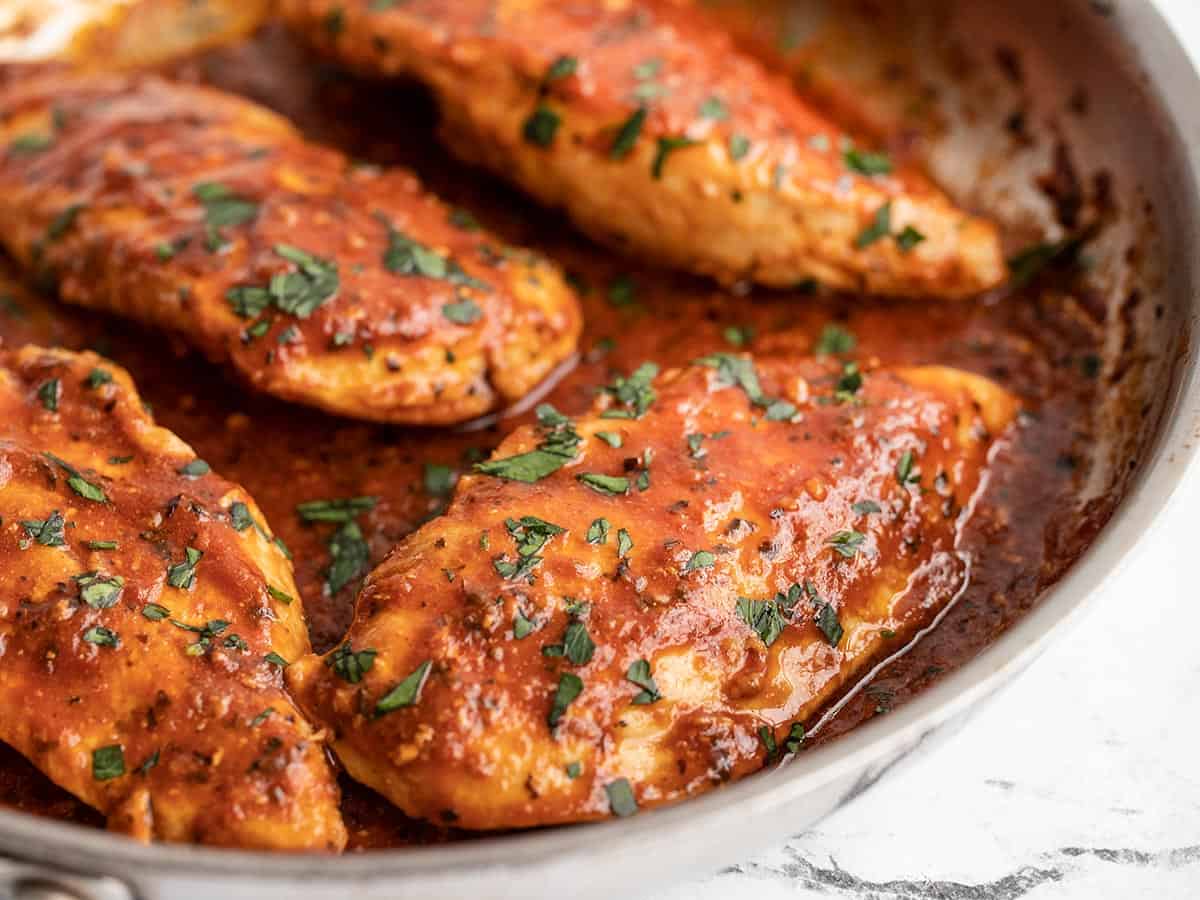 Side view of tomato basil chicken in the skillet