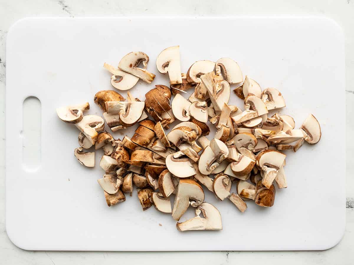 Sliced mushrooms on a cutting board.