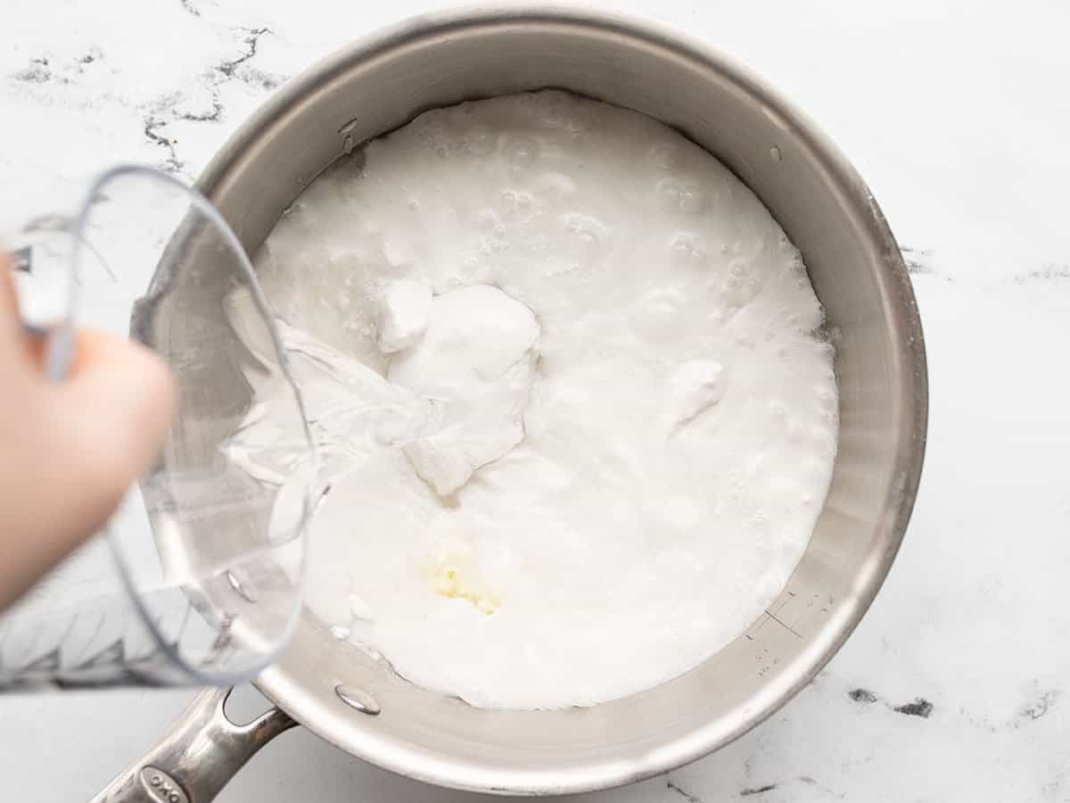 Water being poured into the saucepot.