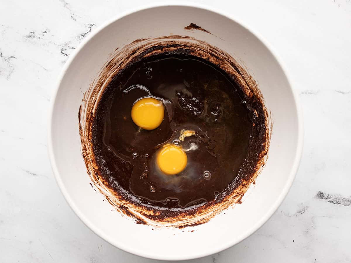 Eggs and vanilla added to batter in the bowl.