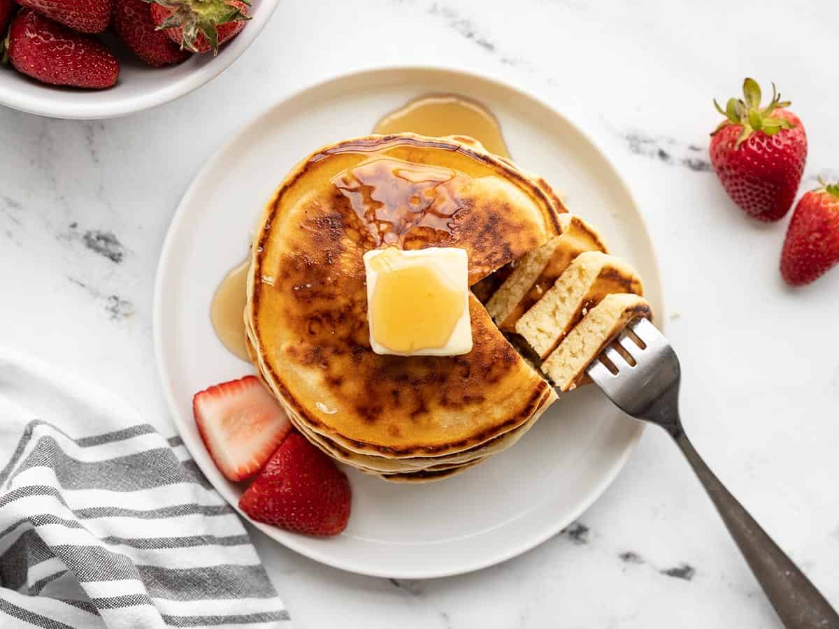 Overhead view of a stack of pancakes with a fork