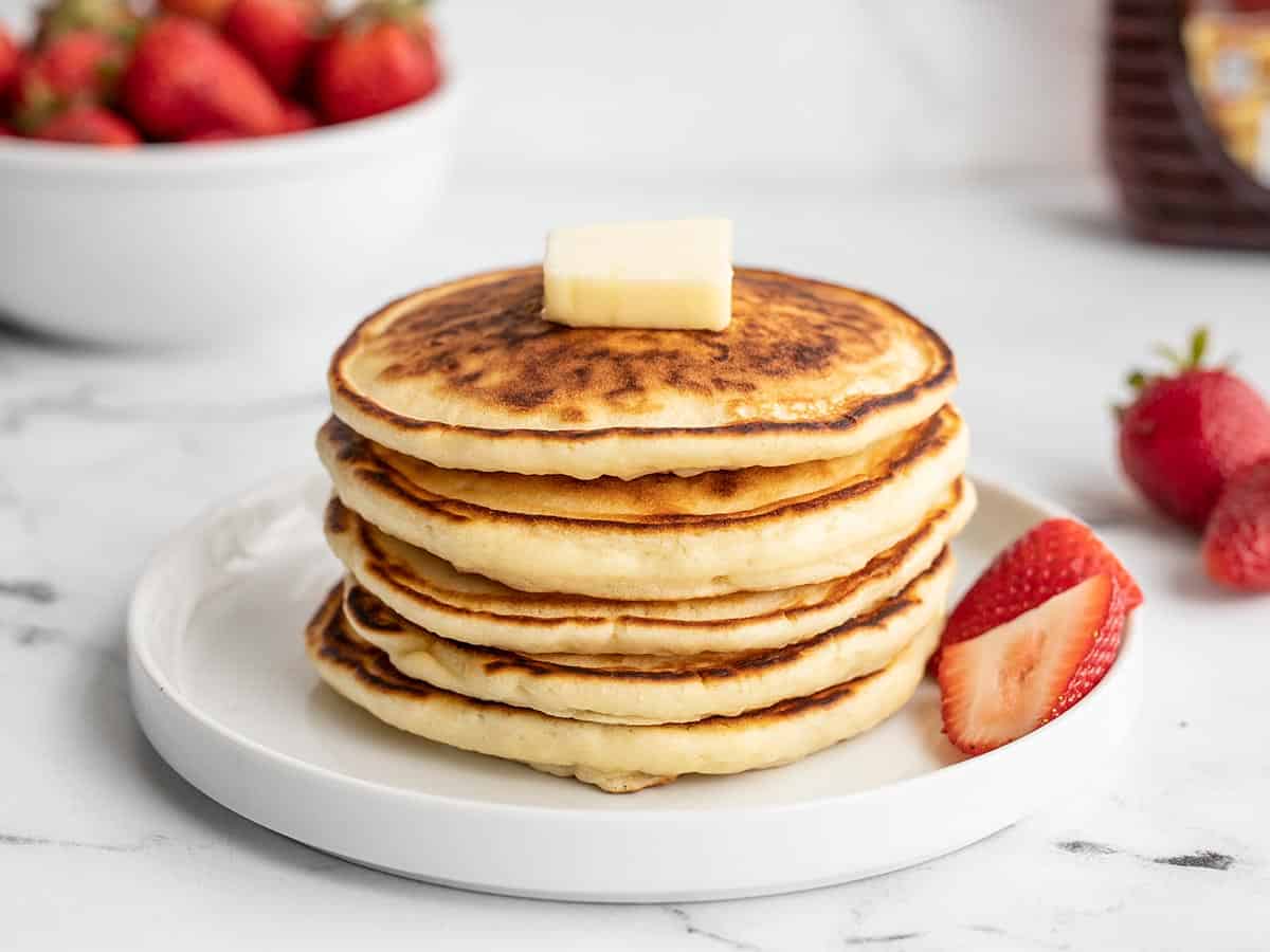 Pancakes in a stick on a plate with butter, no syrup.