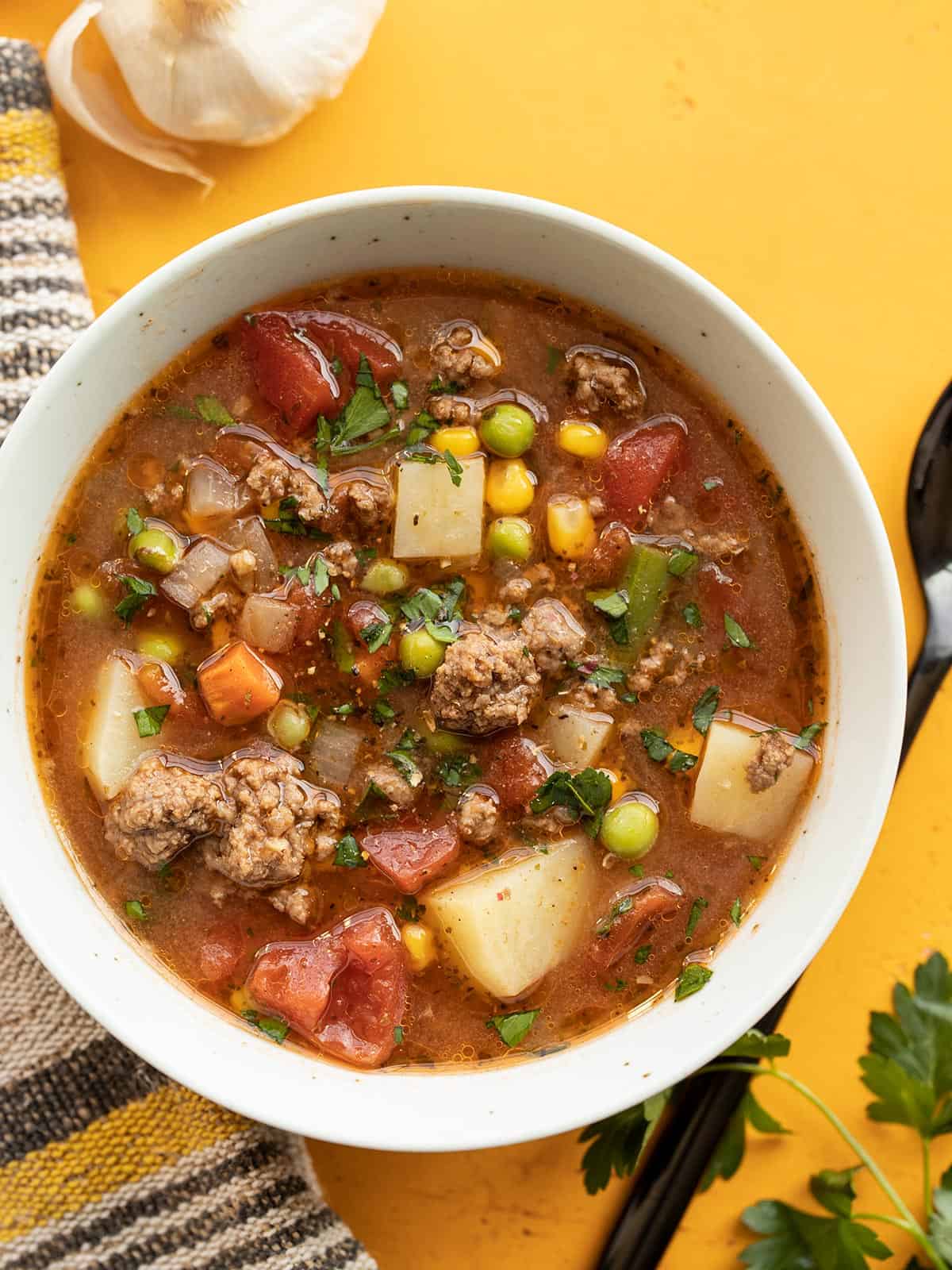 Overhead view of a bowl of vegetable beef soup.