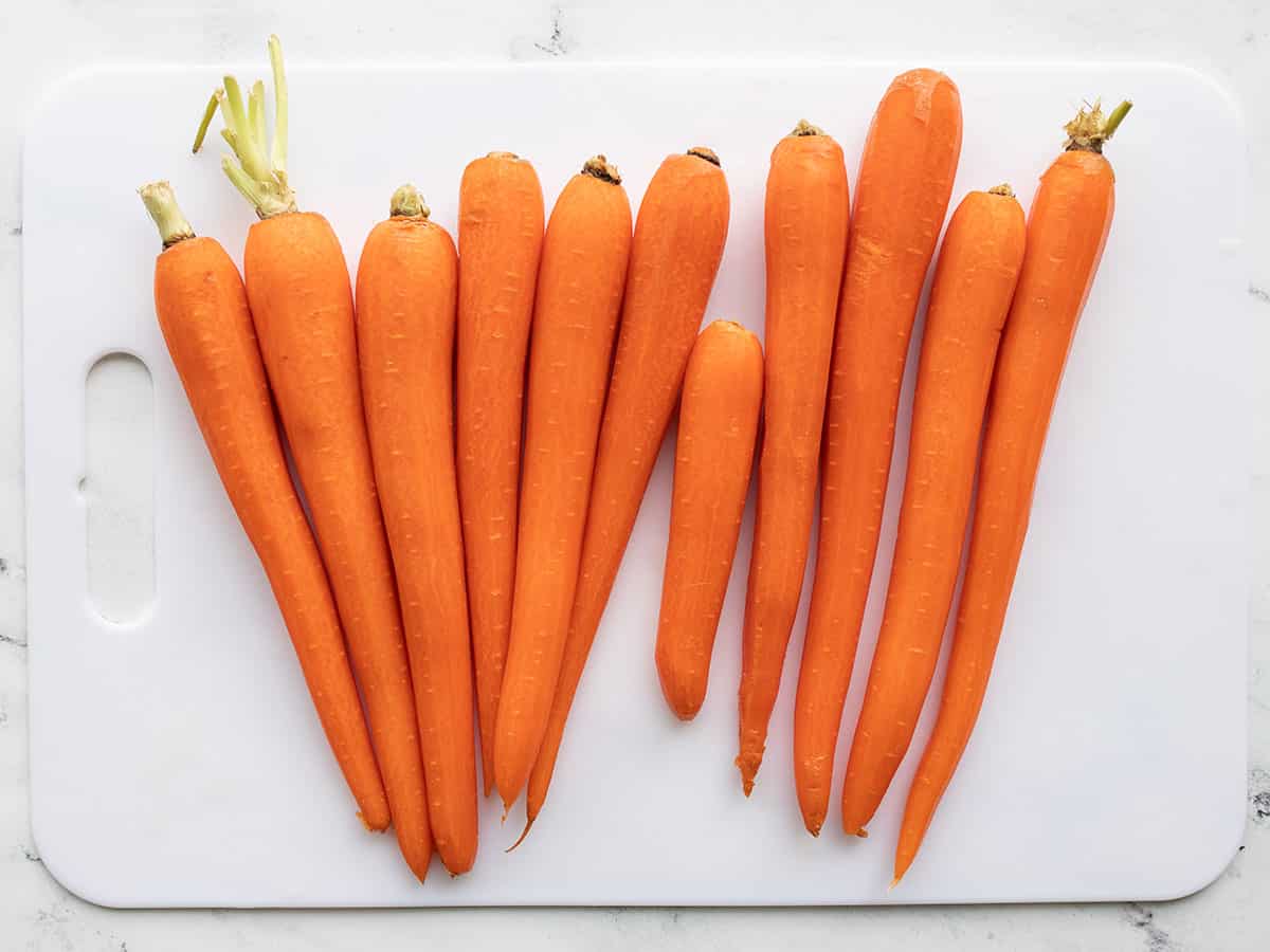 Peeled carrots on a cutting board.