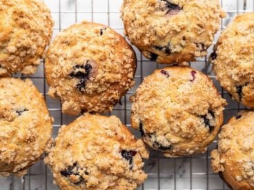 close up overhead view of blueberry muffins with crumble topping.