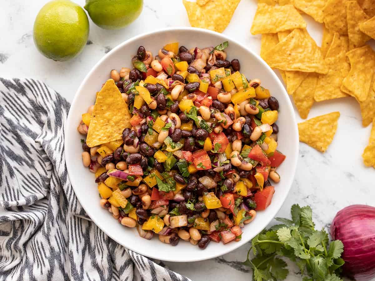 Finished cowboy caviar in a bowl with a chip.