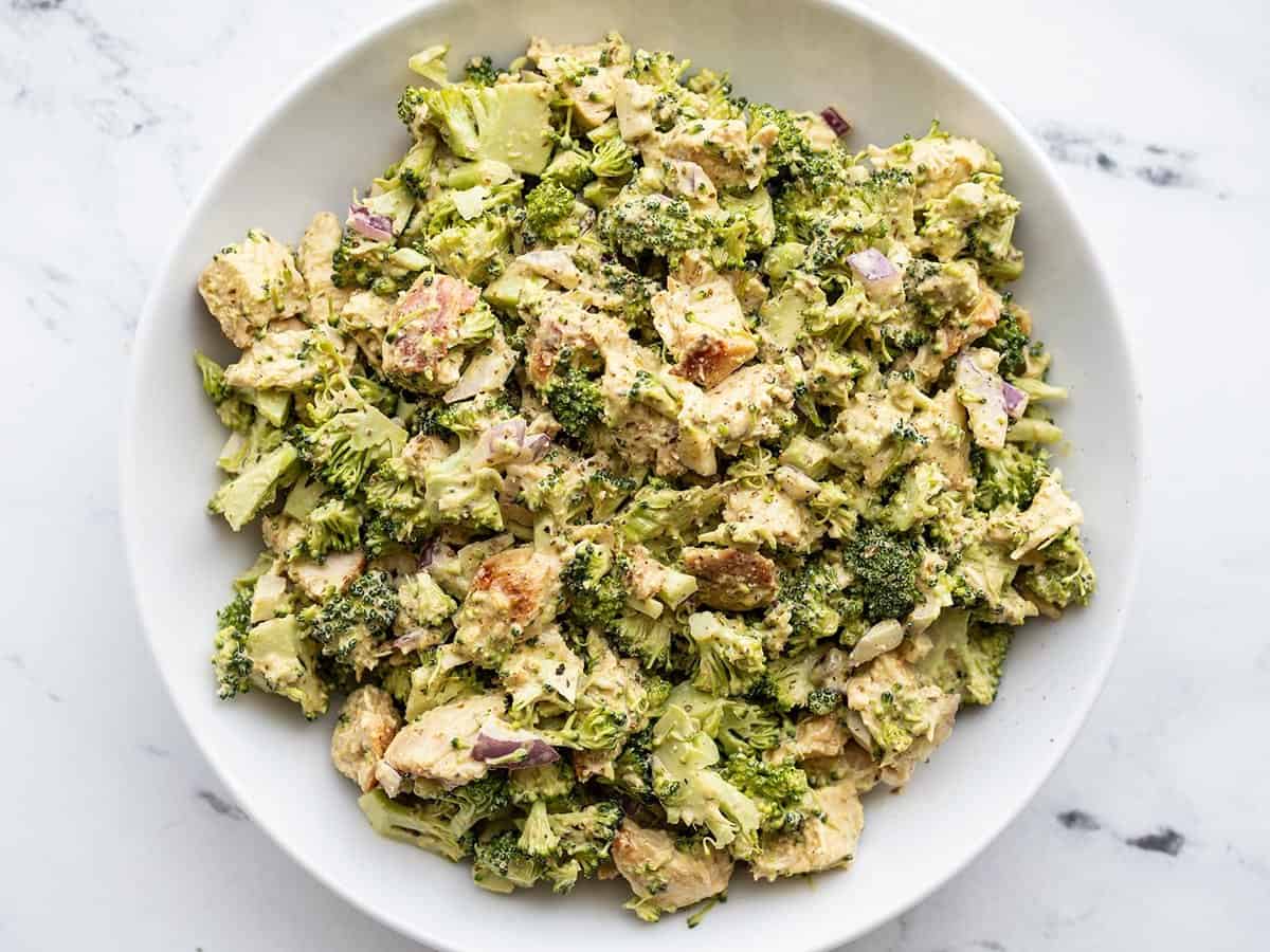 Overhead view of a bowl of pesto chicken and broccoli salad.