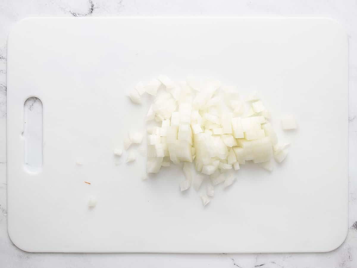 Diced onion on a cutting board.