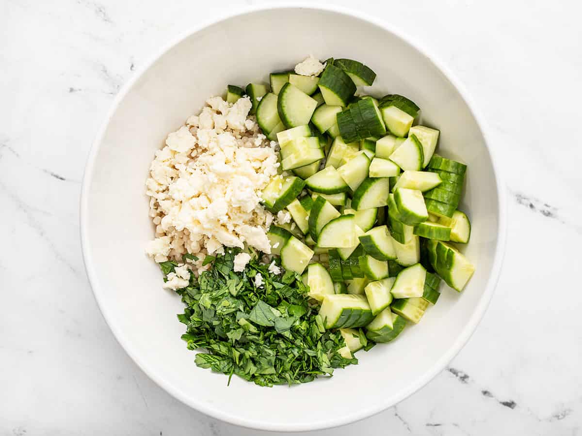 Salad ingredients in the bowl, not mixed.