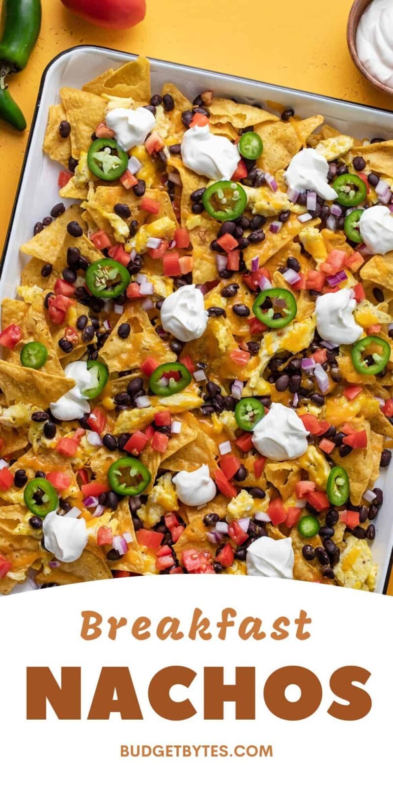 Close up overhead view of breakfast nachos on a baking sheet.