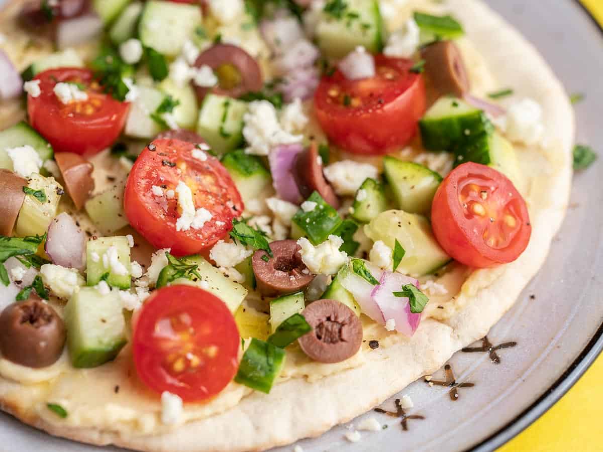 Close up of loaded hummus pita.