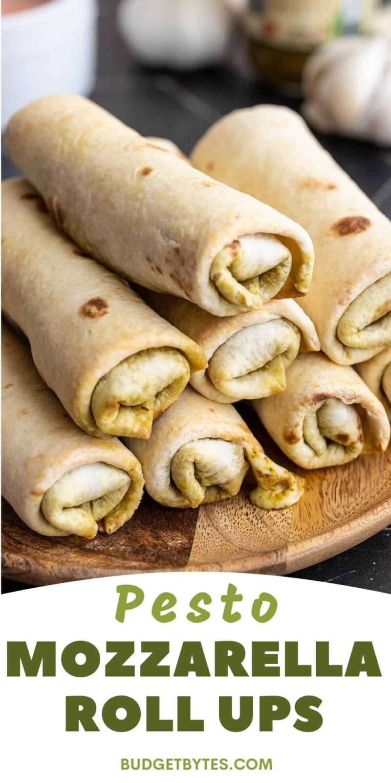 Side view of a plate full of pesto mozzarella roll ups.