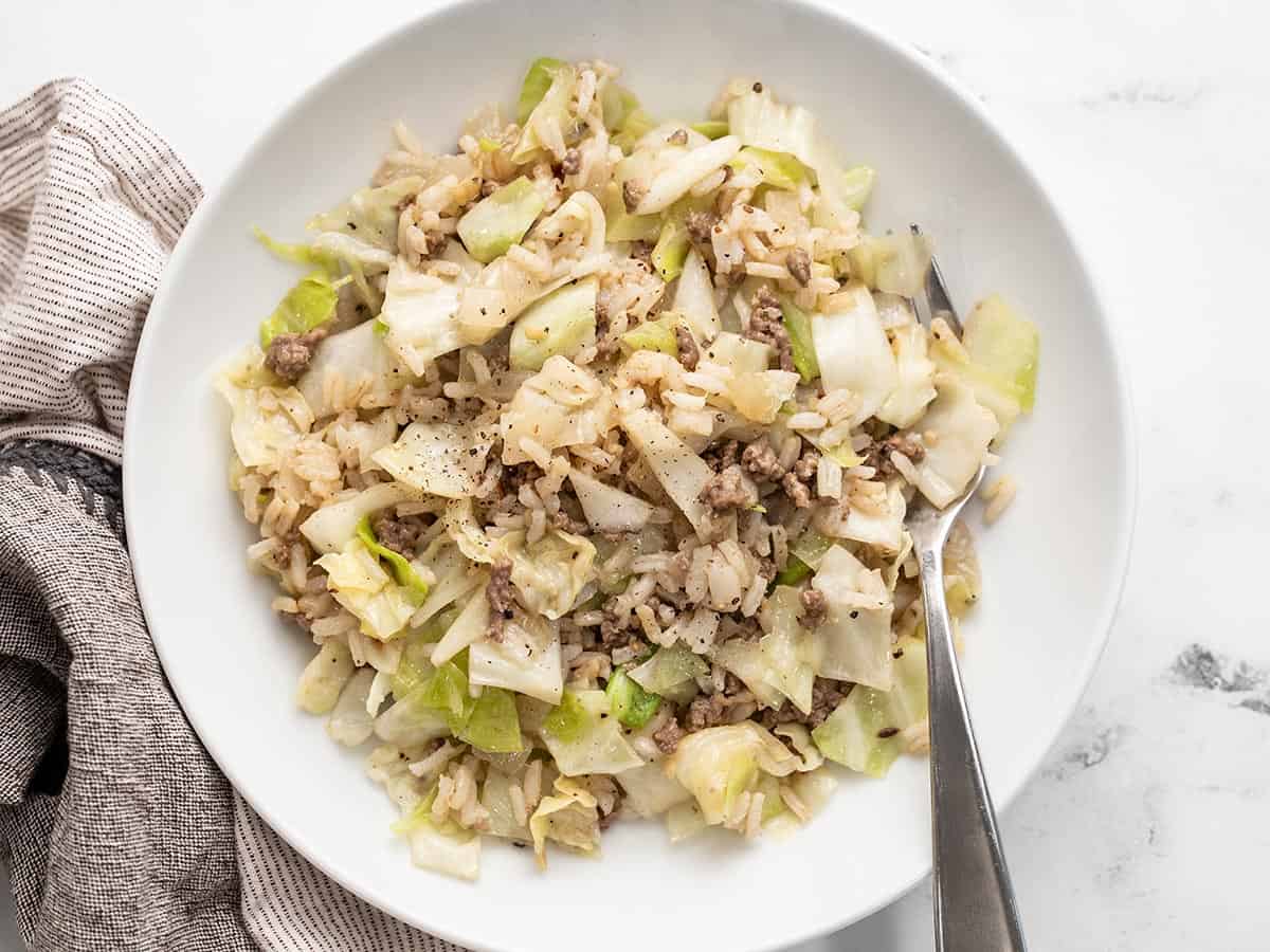 Overhead view of a bowl full of sautéed beef, cabbage, and rice.