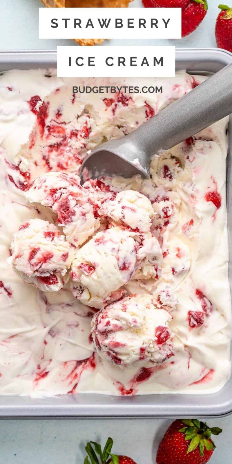 Overhead view of strawberry ice cream being scooped out of the dish.