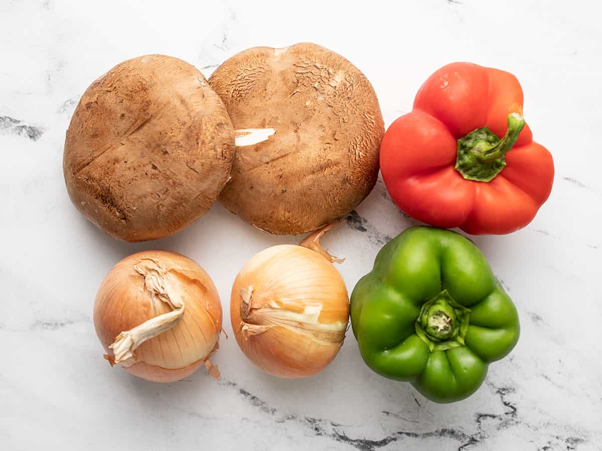 Whole vegetables on a cutting board.