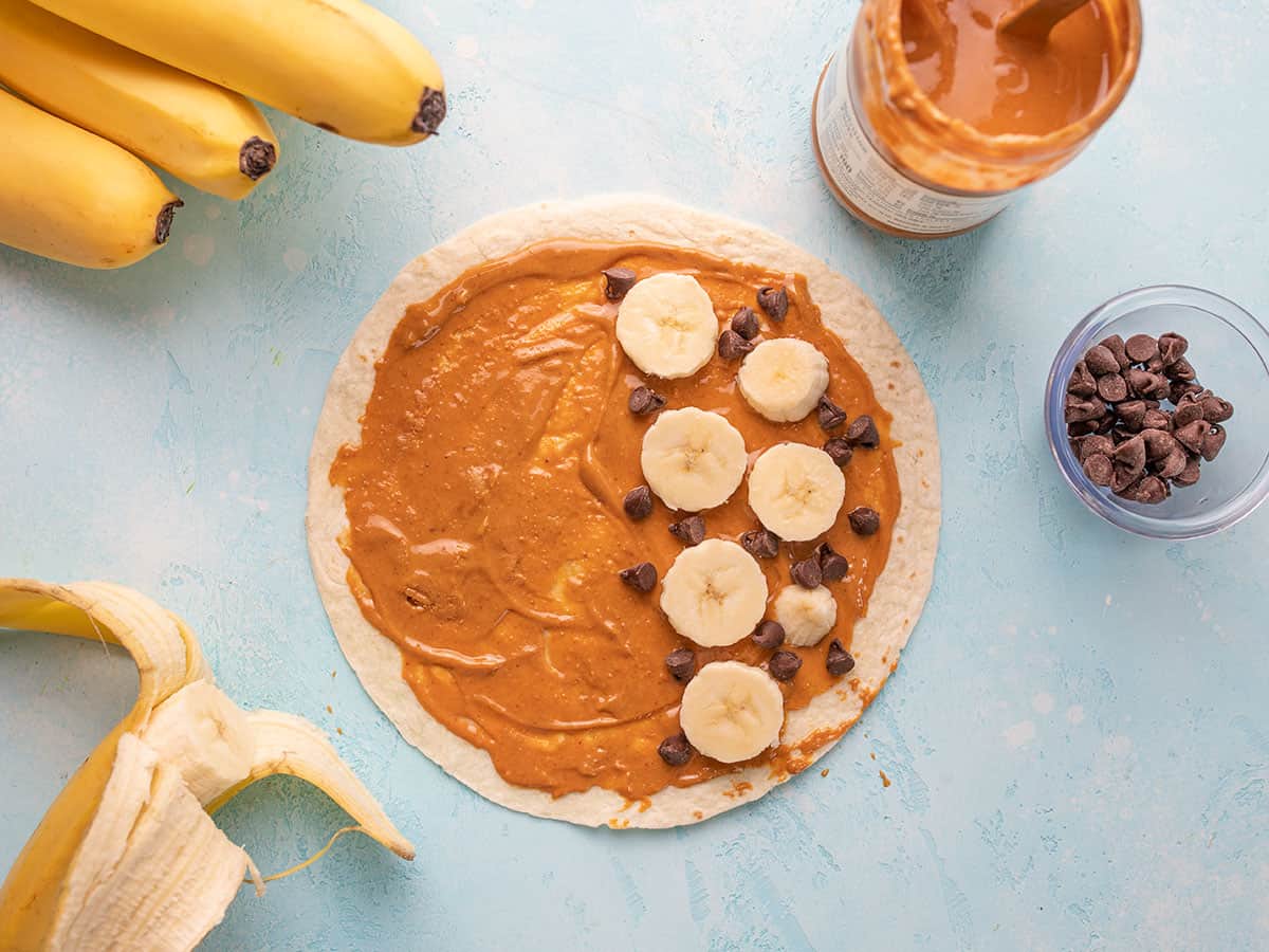 Banana slices and chocolate chips added to the tortilla.