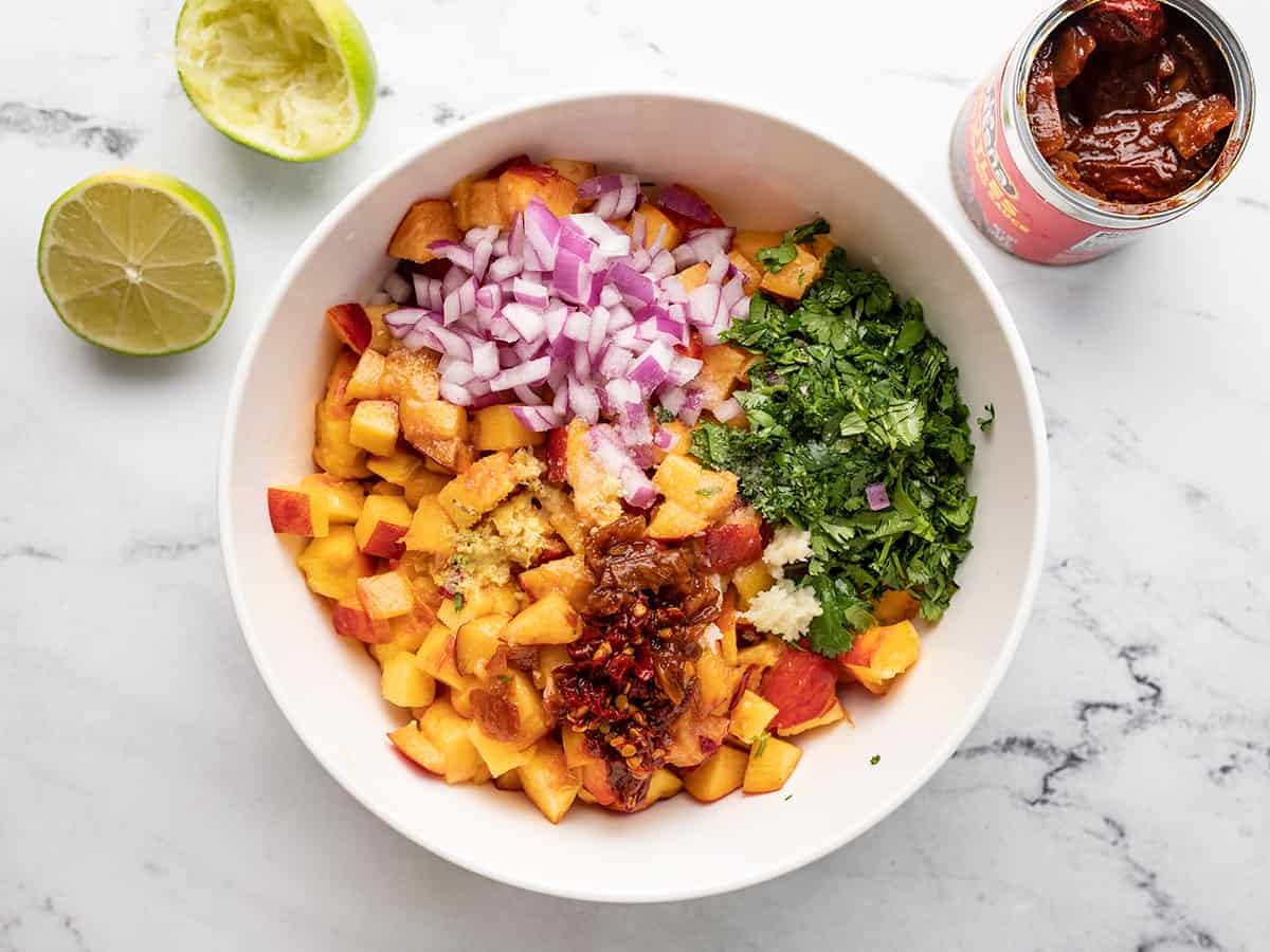 Salsa ingredients in the bowl, not mixed together.