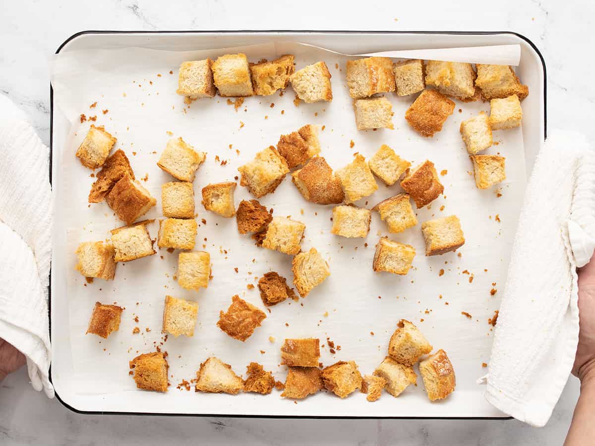 Overhead shot of panzanella salad croutons in a sheet pan.