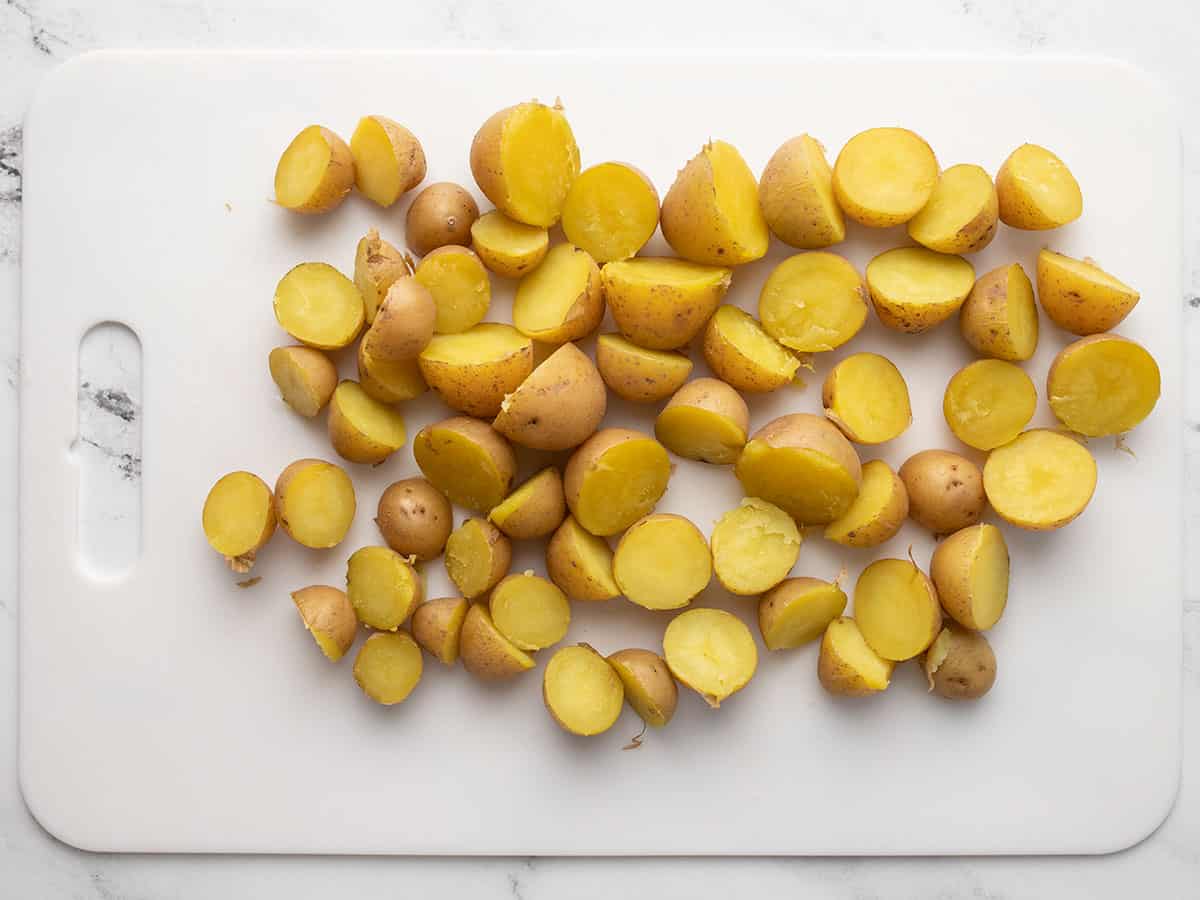 Sliced potatoes on a cutting board.