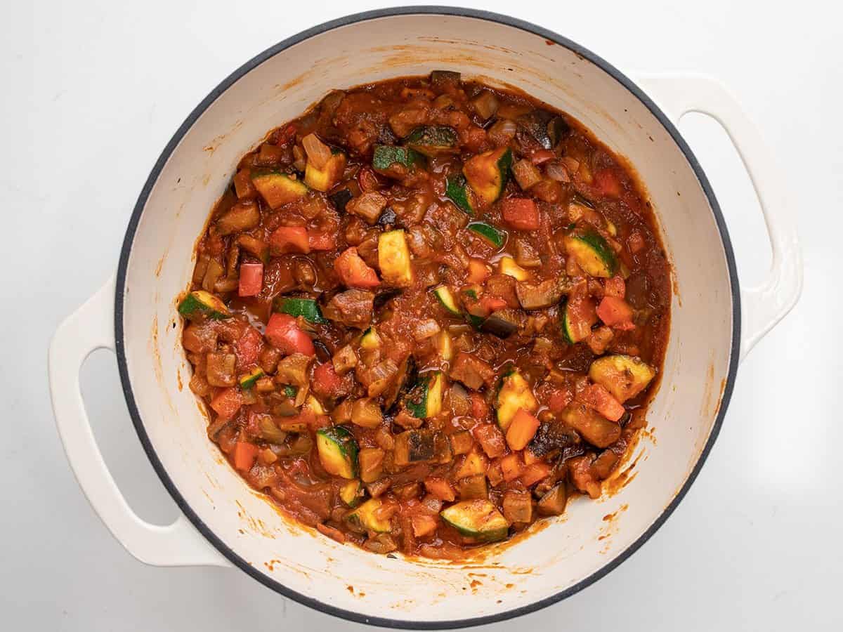 Simmered vegetables in red sauce in the pot.