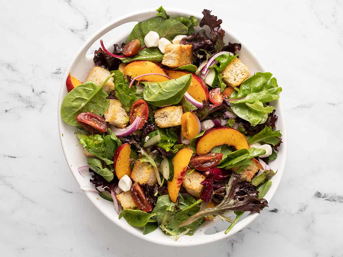 Overhead shot of panzanella salad in a white bowl.