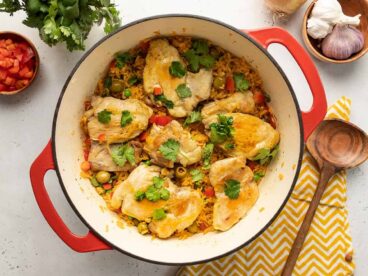 Over head view of arroz con pollo in a red Dutch oven.