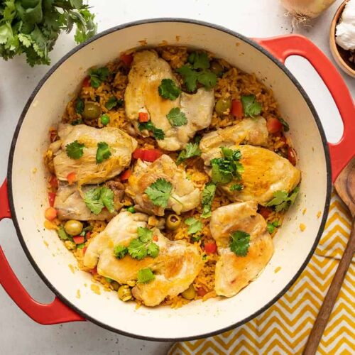 Over head view of arroz con pollo in a red Dutch oven.