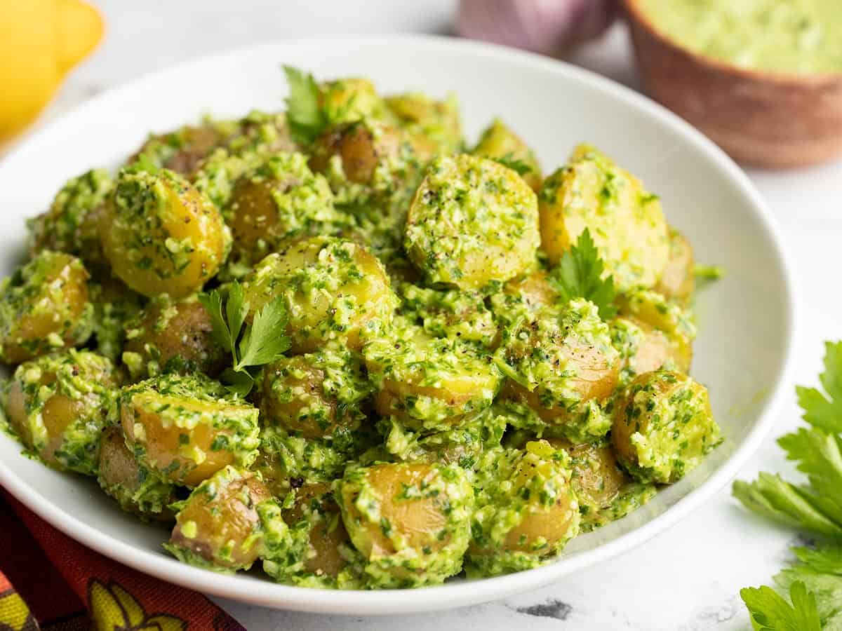 Side view of a bowl of pesto potato salad.