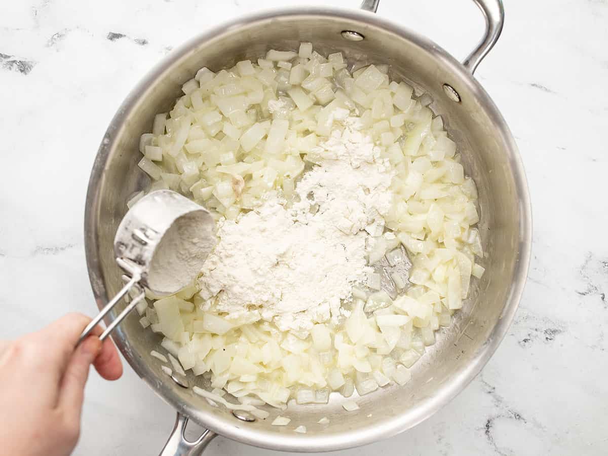 Flour being added to the skillet.