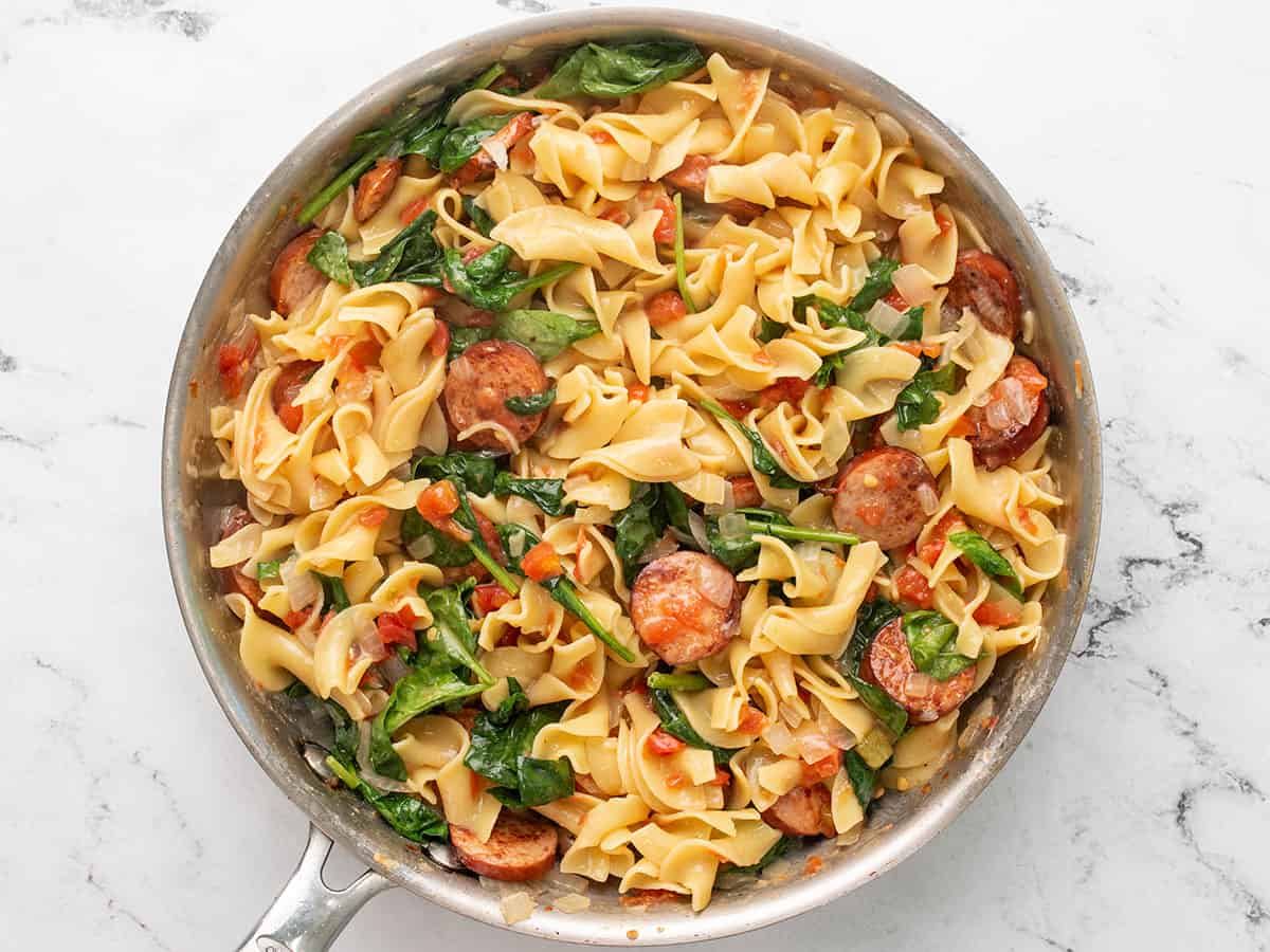 Wilted spinach stirred into the pasta.