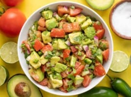 Overhead view of a bowl full of avocado and tomato salad.