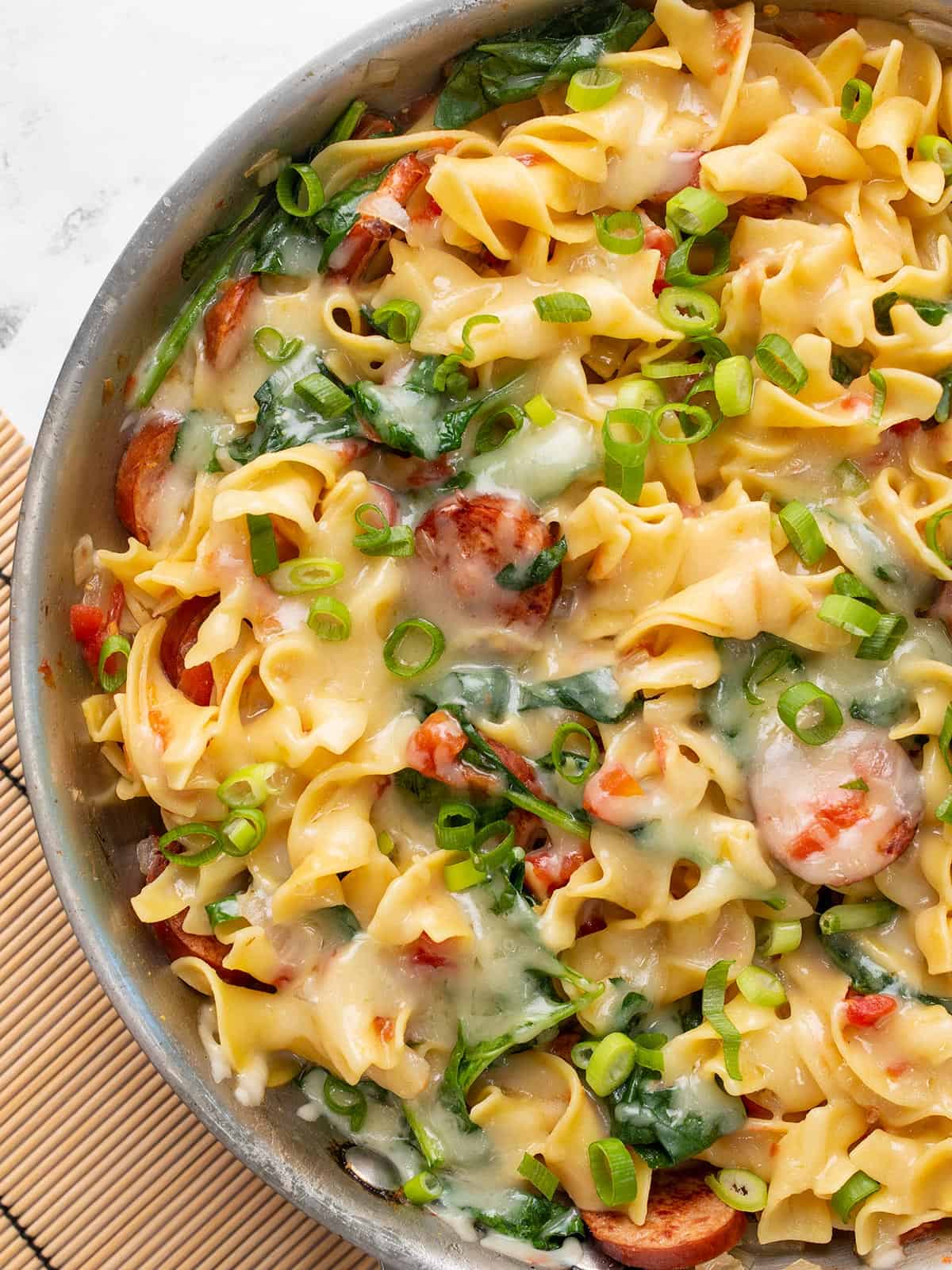 Close up overhead view of Cheesy Sausage Pasta in the skillet.