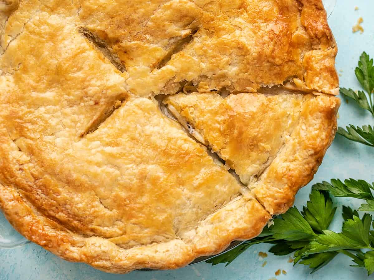 Close up overhead view of a chicken pot pie with a slice cut into it.