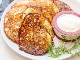 Close up side view of Deruny on a plate with sour cream.