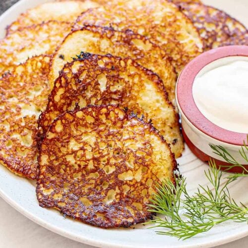 Close up side view of Deruny on a plate with sour cream.