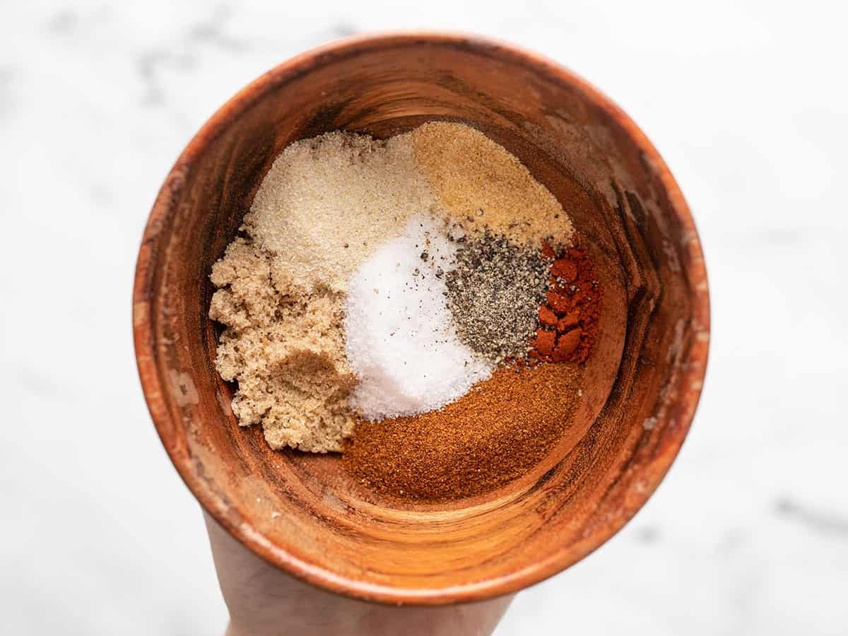 Spices for pulled pork in a small wooden bowl.