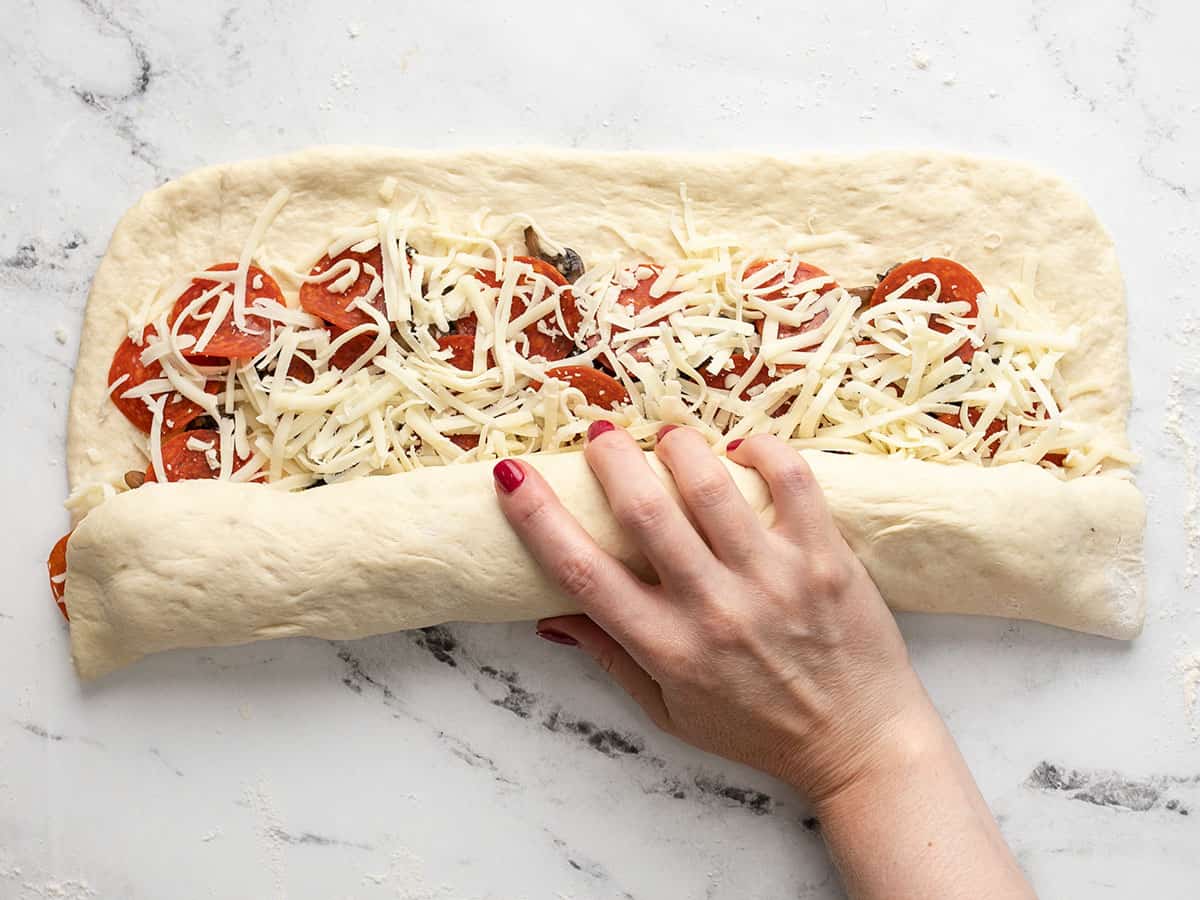 Stromboli being rolled up.