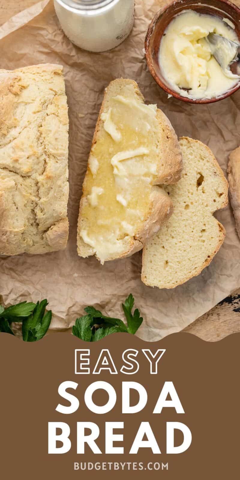 Overhead shot of baked easy soda bread sliced and buttered on parchment.