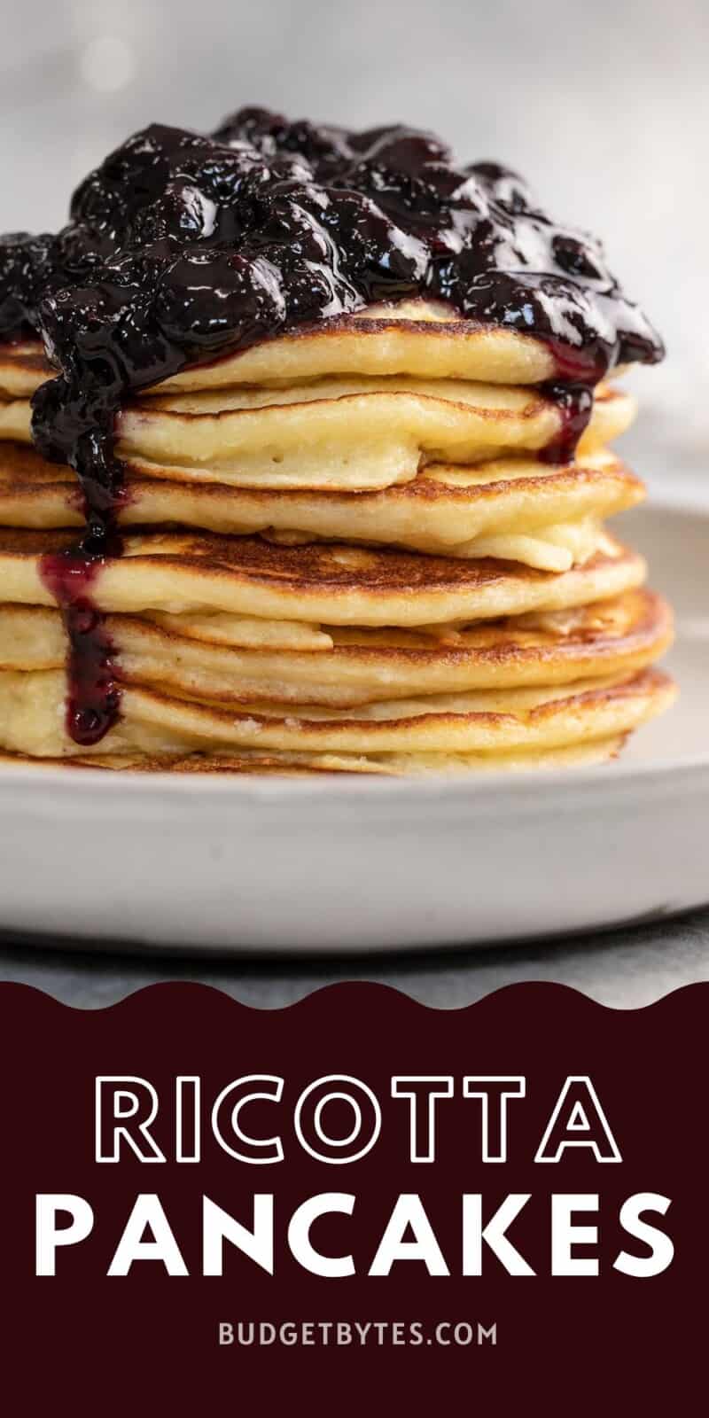 Side shot of a stack of ricotta pancakes with blueberry sauce on top.