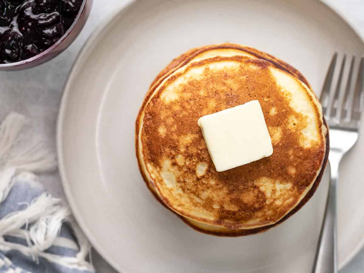 Overhead shot of ricotta pancake stack with a pat of butter.