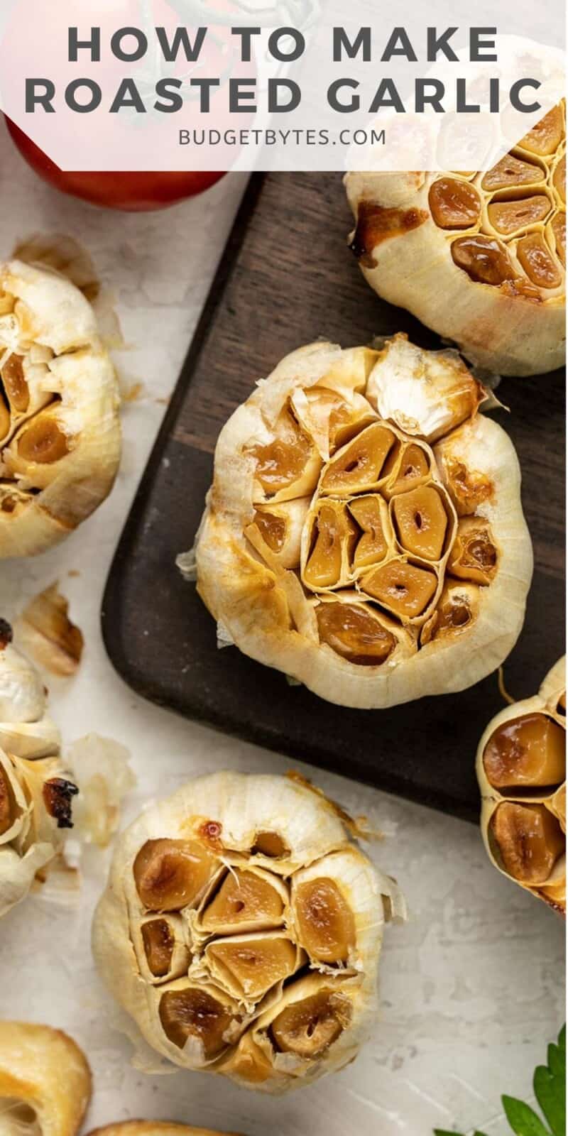 Several heads of roasted garlic scattered on a surface.