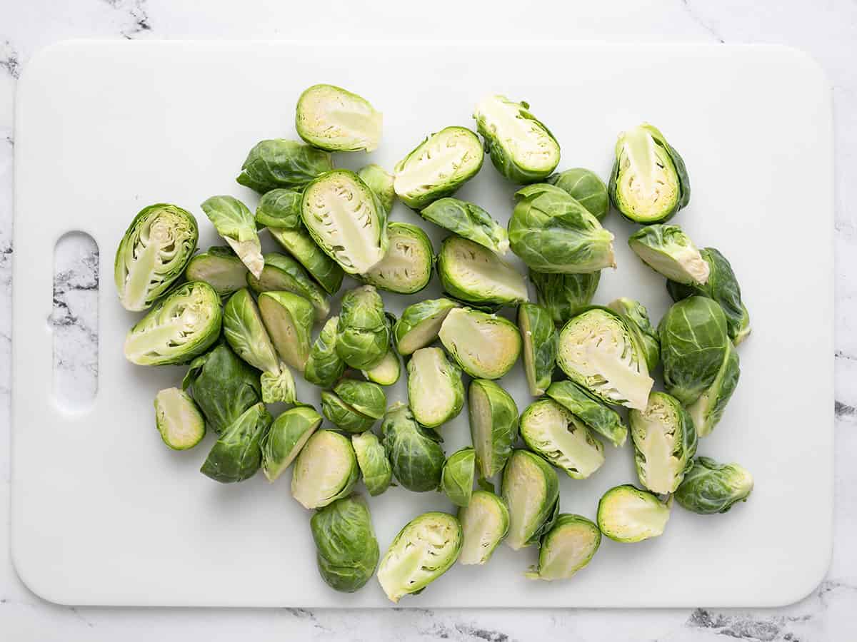 Prepped Brussels sprouts on a cutting board.