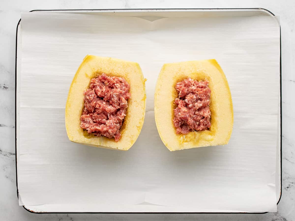 Overhead shot of spaghetti squash stuffed with sausage.